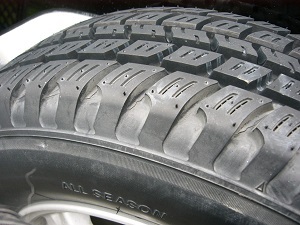 Close-up of black car tire with tread pattern