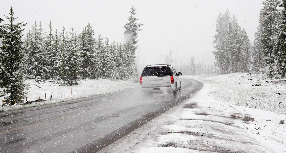 Car running on a snow covered road
