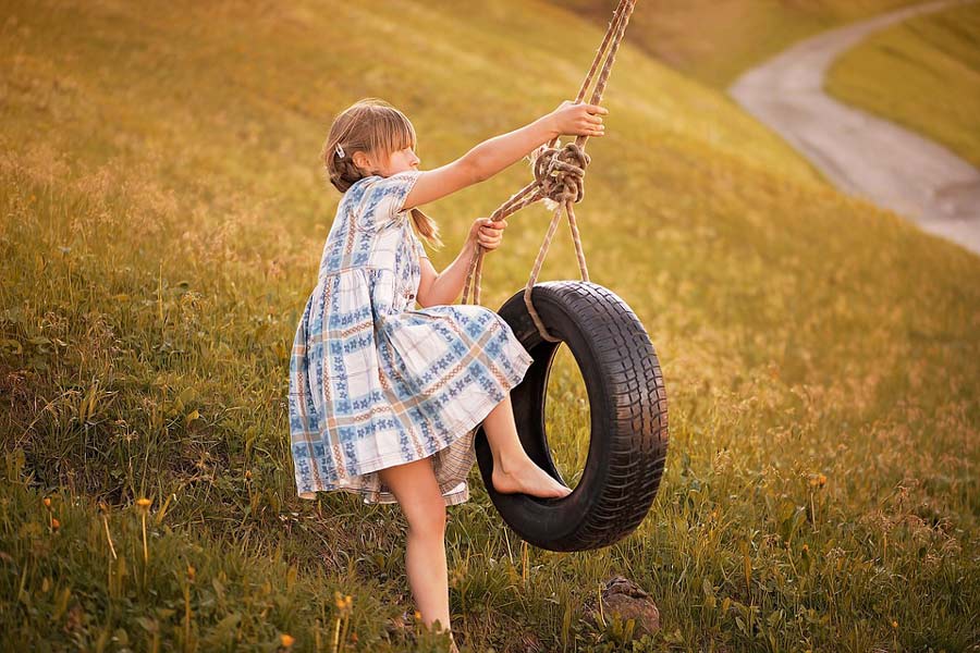 Girl swinging in a tire