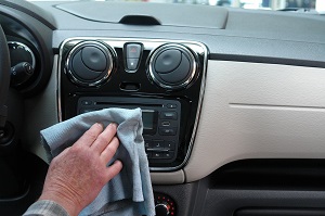 A man cleaning the interior of the car.