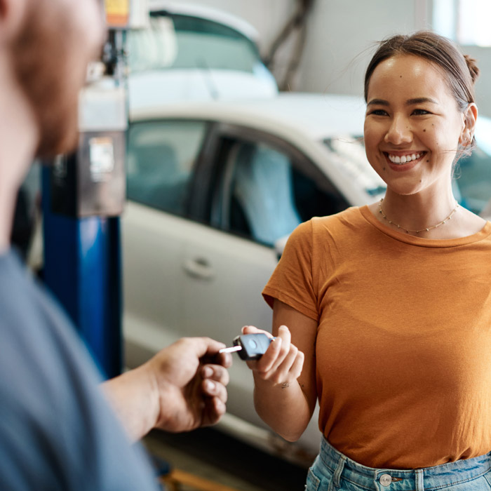 woman giving keys to mechanic