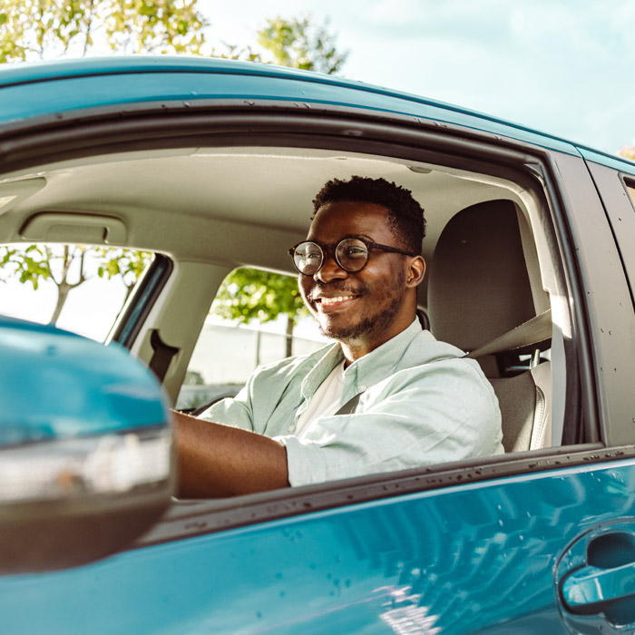 man driving blue car