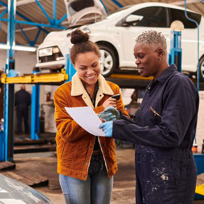 mechanic and customer discussing car diagnostic